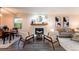 Inviting living area featuring a fireplace, modern decor, and an adjacent dining space at 15491 E Wyoming Dr # A, Aurora, CO 80017