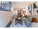 Bright and airy living room with modern furniture, open layout, and access to dining and kitchen areas at 15491 E Wyoming Dr # A, Aurora, CO 80017