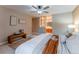 Main bedroom featuring a bench, carpeted floors, and access to the main bathroom at 15491 E Wyoming Dr # A, Aurora, CO 80017