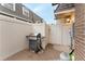 A private patio features white fencing and a gas grill, perfect for outdoor cooking at 15491 E Wyoming Dr # A, Aurora, CO 80017