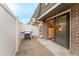 Outdoor patio with white fencing, gas grill, and sliding glass door to the interior at 15491 E Wyoming Dr # A, Aurora, CO 80017