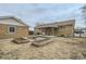 Exterior view of backyard showcasing yard space, patio with awning, and detached garage at 283 Garland Dr, Northglenn, CO 80233