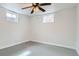 Basement with painted floor and two windows at 283 Garland Dr, Northglenn, CO 80233