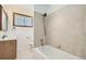 Bathroom features a shower over tub and wood-trimmed window at 283 Garland Dr, Northglenn, CO 80233