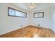 Bedroom features two large windows with natural light and hardwood floors at 283 Garland Dr, Northglenn, CO 80233