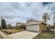 Street view showing detached garage, driveway and well maintained yard at 283 Garland Dr, Northglenn, CO 80233
