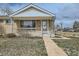Charming brick home with a cozy front porch and neat landscaping, offering a welcoming curb appeal at 283 Garland Dr, Northglenn, CO 80233