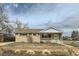 Charming single-story home with a brick facade, tidy landscaping, and a cozy front porch at 283 Garland Dr, Northglenn, CO 80233