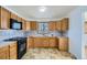 Functional kitchen with wooden cabinets, tile backsplash, and modern appliances ready for cooking at 283 Garland Dr, Northglenn, CO 80233