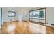 Bright living room with hardwood floors, large windows, and a view, perfect for Gathering gatherings at 283 Garland Dr, Northglenn, CO 80233
