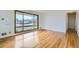 Spacious living room featuring gleaming hardwood floors, a large window, and lots of natural light at 283 Garland Dr, Northglenn, CO 80233