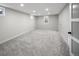 Large basement space with plush carpet and natural light from egress windows at 1660 S Kingston Way, Aurora, CO 80012
