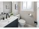 Bathroom featuring modern sink, updated fixtures, decorative art and white tiled floors at 1660 S Kingston Way, Aurora, CO 80012