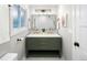 Charming bathroom with an olive green vanity, dual sinks, and contemporary fixtures at 1660 S Kingston Way, Aurora, CO 80012