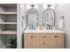 Bathroom vanity featuring double sinks, modern fixtures, decorative mirrors and open shelving at 1660 S Kingston Way, Aurora, CO 80012