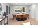 Staged dining room showcasing a large window, modern lighting, and seating for six at 1660 S Kingston Way, Aurora, CO 80012