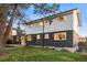 Exterior view of a two-story home featuring a well-manicured lawn and stylish black and white facade at 1660 S Kingston Way, Aurora, CO 80012