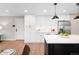 Bright and well-equipped kitchen with an island bar, stainless steel appliances, and modern lighting at 1660 S Kingston Way, Aurora, CO 80012