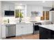 Updated kitchen features stainless steel appliances, white subway tile, and quartz countertops at 1660 S Kingston Way, Aurora, CO 80012
