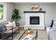 Bright living room featuring a brick fireplace, large windows, modern furniture, and stylish decor at 1660 S Kingston Way, Aurora, CO 80012