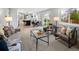 Open concept living room featuring modern decor, seamless flow to the kitchen, and outdoor access at 1660 S Kingston Way, Aurora, CO 80012