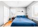Cozy bedroom with a large window, hardwood floors, and a comfortable bed with blue comforter at 85 N Grant St # 30, Denver, CO 80203