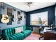 Bedroom with accent wall, green velvet sofa and window views at 85 N Grant St # 30, Denver, CO 80203