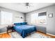 Bright bedroom features two large windows, hardwood floors, and a comfy bed with a blue comforter at 85 N Grant St # 30, Denver, CO 80203