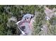 Beautiful home with a large wooden deck and garage nestled in a lush mountain forest at 10439 Christopher Dr, Conifer, CO 80433