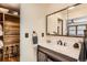 Bathroom with vanity and a walk-in closet with beautiful wood, providing ample storage space at 10439 Christopher Dr, Conifer, CO 80433