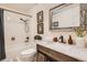 Bathroom showcasing a vanity with a decorative mirror, complemented by tiled floors and a shower at 10439 Christopher Dr, Conifer, CO 80433