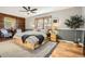 Spacious bedroom features hardwood floors, a ceiling fan, and a large window for natural light at 10439 Christopher Dr, Conifer, CO 80433