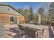 Inviting wood deck with dining set, offering peaceful views of the surrounding landscape at 10439 Christopher Dr, Conifer, CO 80433