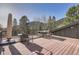 Spacious wooden deck featuring an outdoor dining set and forest views at 10439 Christopher Dr, Conifer, CO 80433