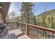 Deck overlooking a forest with mountain views at 10439 Christopher Dr, Conifer, CO 80433