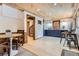 Finished basement with dining area, bar and cabinets, a spiral staircase and tile floor at 10439 Christopher Dr, Conifer, CO 80433