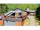 Rustic log home with a large deck, perfect for enjoying the surrounding natural beauty at 10439 Christopher Dr, Conifer, CO 80433