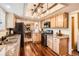 Modern kitchen with granite countertops, wooden cabinets, and stainless steel appliances, perfect for cooking at 10439 Christopher Dr, Conifer, CO 80433