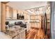 Well-equipped kitchen featuring wooden cabinets, granite countertops, and modern appliances for culinary enthusiasts at 10439 Christopher Dr, Conifer, CO 80433