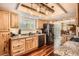 Bright kitchen with granite countertops, wooden cabinets and floors, and stainless steel appliances at 10439 Christopher Dr, Conifer, CO 80433