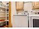 Functional laundry room with modern washer and dryer, plus shelving for organized storage at 10439 Christopher Dr, Conifer, CO 80433