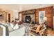 Inviting living room with stone fireplace, hardwood floors, and stylish furnishings for a comfortable space at 10439 Christopher Dr, Conifer, CO 80433