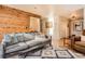 Comfortable living room with a cozy sofa, hardwood floors, and access to other rooms at 10439 Christopher Dr, Conifer, CO 80433