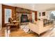 Comfortable living room featuring a stone fireplace, hardwood floors, and cozy decor for relaxation at 10439 Christopher Dr, Conifer, CO 80433