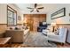 Cozy living room featuring natural light, comfortable seating, and a charming wood-paneled accent wall at 10439 Christopher Dr, Conifer, CO 80433
