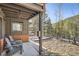 Covered porch with seating, providing a relaxing outdoor space with mountain views at 10439 Christopher Dr, Conifer, CO 80433