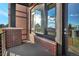 Private balcony with brick wall and sliding glass door at 6618 E Lowry Blvd # 210, Denver, CO 80230