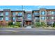Modern condo building with attractive landscaping and convenient street access at 6618 E Lowry Blvd # 210, Denver, CO 80230