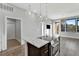 Modern kitchen with island and stainless steel appliances at 6618 E Lowry Blvd # 210, Denver, CO 80230