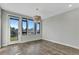 Bright living room with hardwood floors, large windows, and access to a balcony at 6618 E Lowry Blvd # 210, Denver, CO 80230